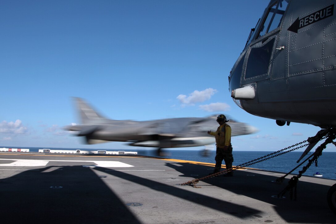 U.S.S. BONHOMME RICHARD, At Sea - An AV-8B Harrier from Marine Attack Squadron 542 lifts off during carrier landing qualification on the moving deck of the U.S.S. Bonhomme Richard, August 27. A detachment of six Harriers serves as the fixed wing asset of the 31st Marine Expeditionary Unit's Air Combat Element.