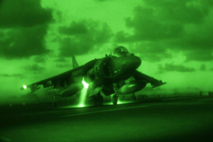 U.S.S. BONHOMME RICHARD, At Sea - An AV-8B Harrier from Marine Attack Squadron 542 completes a vertical landing for night time carrier landing qualification on the moving deck of the U.S.S. Bonhomme Richard, August 27. A detachment of six Harriers serves as the fixed wing asset of the 31st Marine Expeditionary Unit's Air Combat Element.
