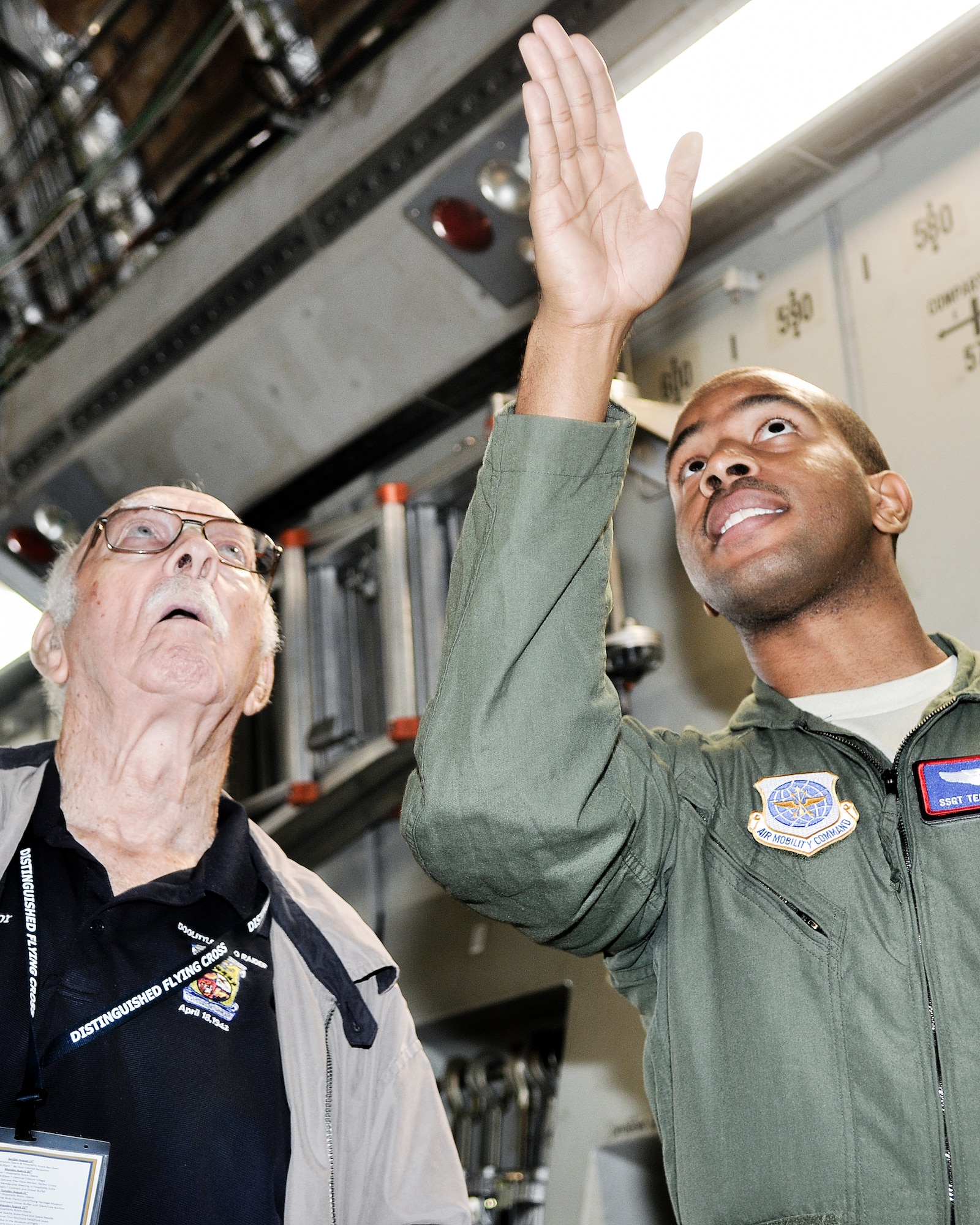 Edward Saylor, Distinguished Flying Cross Medal recipient and Doolittle Raider, speaks with Staff Sgt. Terrance Johnson, 4th Airlift Squadron loadmaster, Aug. 22, 2012, aboard a C-17 Globemaster III aircraft at Joint Base Lewis-McChord, Wash. Members of the Distinguished Flying Cross Society and their guests met with Airmen and got an up-close look at a C-17 aircraft. (U.S. Air Force photo/Staff Sgt. Sean Tobin)