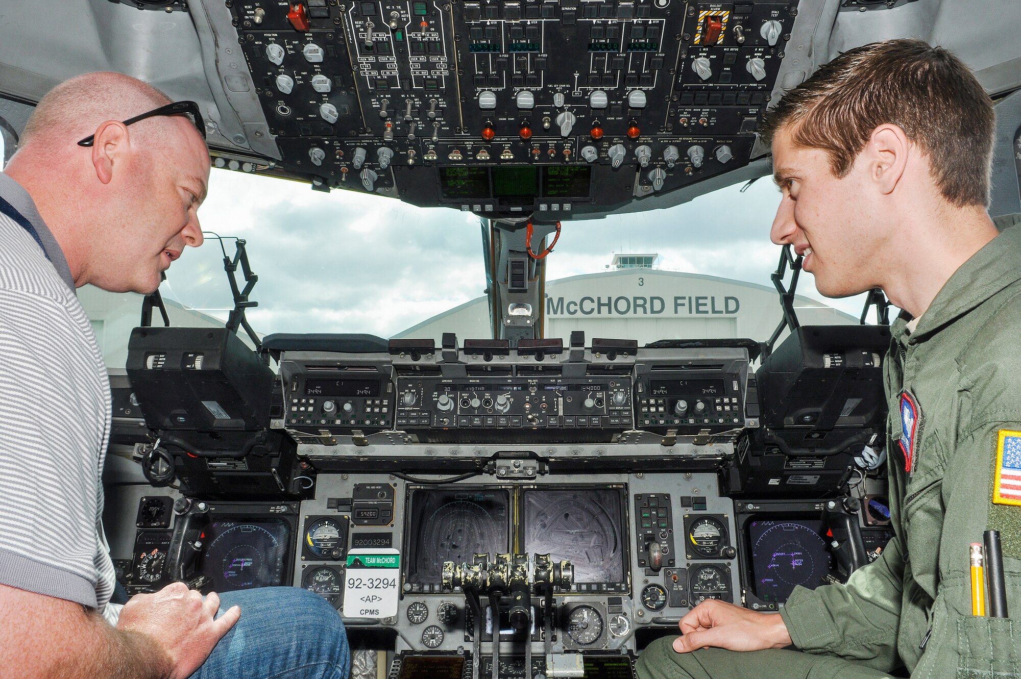 Sean Perry, guest of a Distinguished Flying Cross Medal recipient, speaks with 1st Lt. Robert Petithomme, 4th Airlift Squadron pilot, Aug. 22, 2012 about the various flight controls aboard a C-17 Globemaster III aircraft at Joint Base Lewis-McChord, Wash.  Members of the Distinguished Flying Cross Society and their guests met with Airmen and got an up-close look at a C-17 aircraft. (U.S. Air Force photo/Staff Sgt. Sean Tobin)