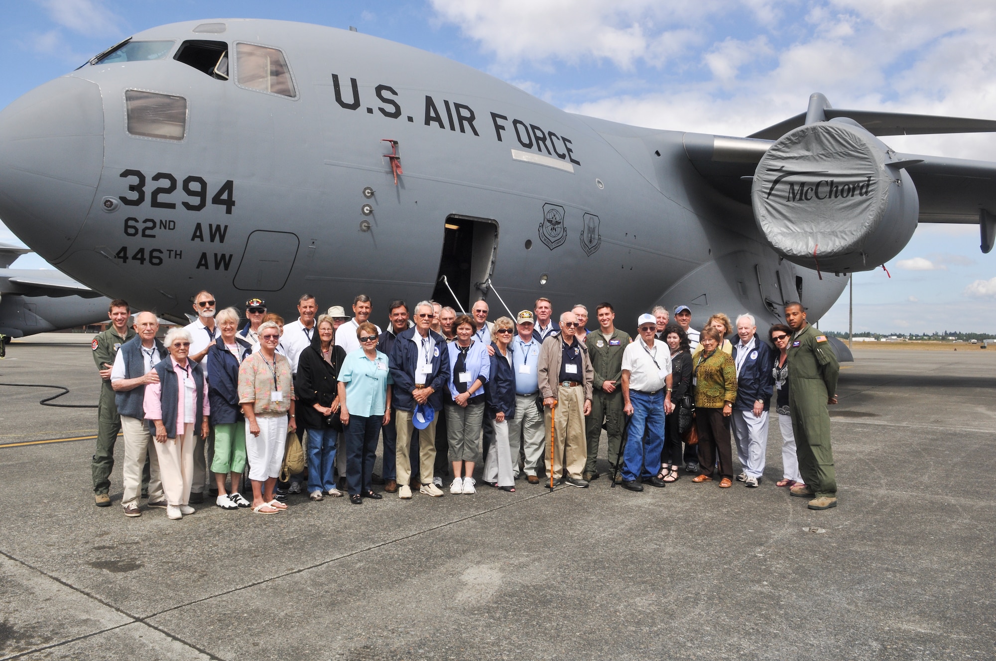 Members of the Distinguished Flying Cross Society and their guests stand with aircrew members Aug. 22, 2012, in front of a C-17 Globemaster III aircraft at Joint Base Lewis-McChord, Wash. The group met with Airman and got an up-close look at a C-17 aircraft. (U.S. Air Force photo/Staff Sgt. Sean Tobin)