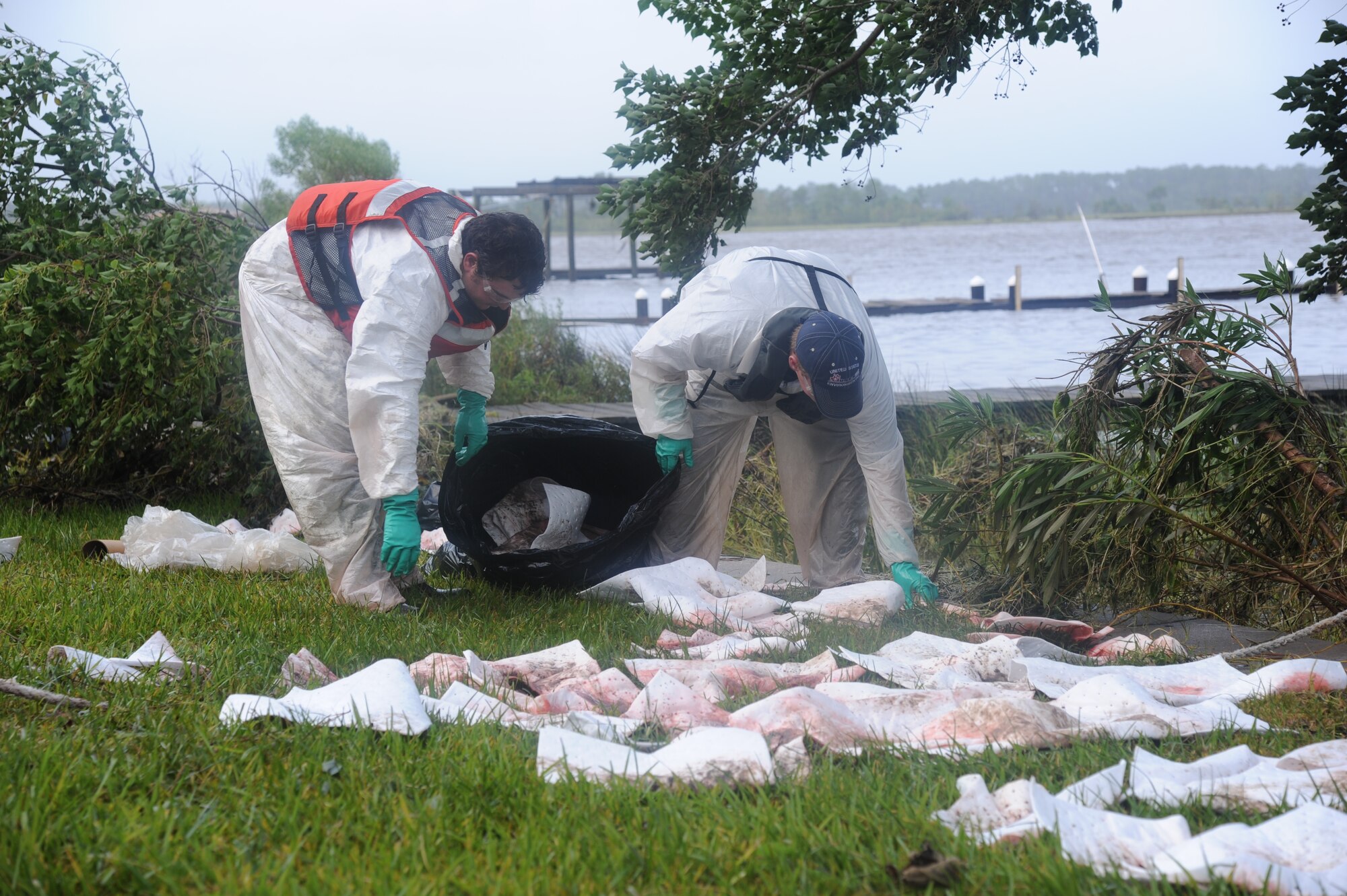 Members of the United States Environmental Services of Biloxi clean up diesel fuel following a nearly 3,000-gallon diesel fuel spill Aug. 30, 2012.  The fuel leaked from a generator on Keesler Air Force Base, Miss., into a storm drain leading to the Biloxi Back Bay.  (U.S. Air Force photo by Kemberly Groue)