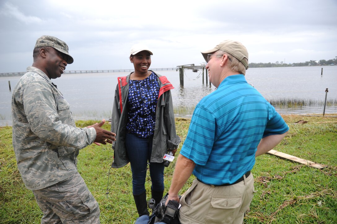 Col. Mark Vivians, 81st Mission Support Group commander, speaks to Charisse Gibson, WLOX reporter, and Rodney Billingsley, WLOX videographer, about how Keesler Air Force Base is responding to a nearly 3,000-gallon diesel fuel spill Aug. 30, 2012.  The fuel leaked from a generator from the base commissary into a storm drain leading to the Biloxi Back Bay, Miss.  (U.S. Air Force photo by Kemberly Groue)