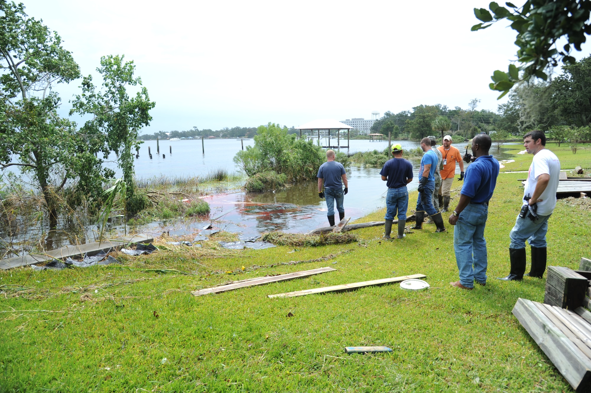 United States Environmental Services of Biloxi and Keesler Air Force Base officials assess the Biloxi Back Bay as the base responds to a nearly 3,000-gallon diesel fuel spill Aug. 30, 2012.  The fuel leaked from a generator from the base commissary into a storm drain leading to the Biloxi Back Bay, Miss.  (U.S. Air Force photo by Kemberly Groue)
