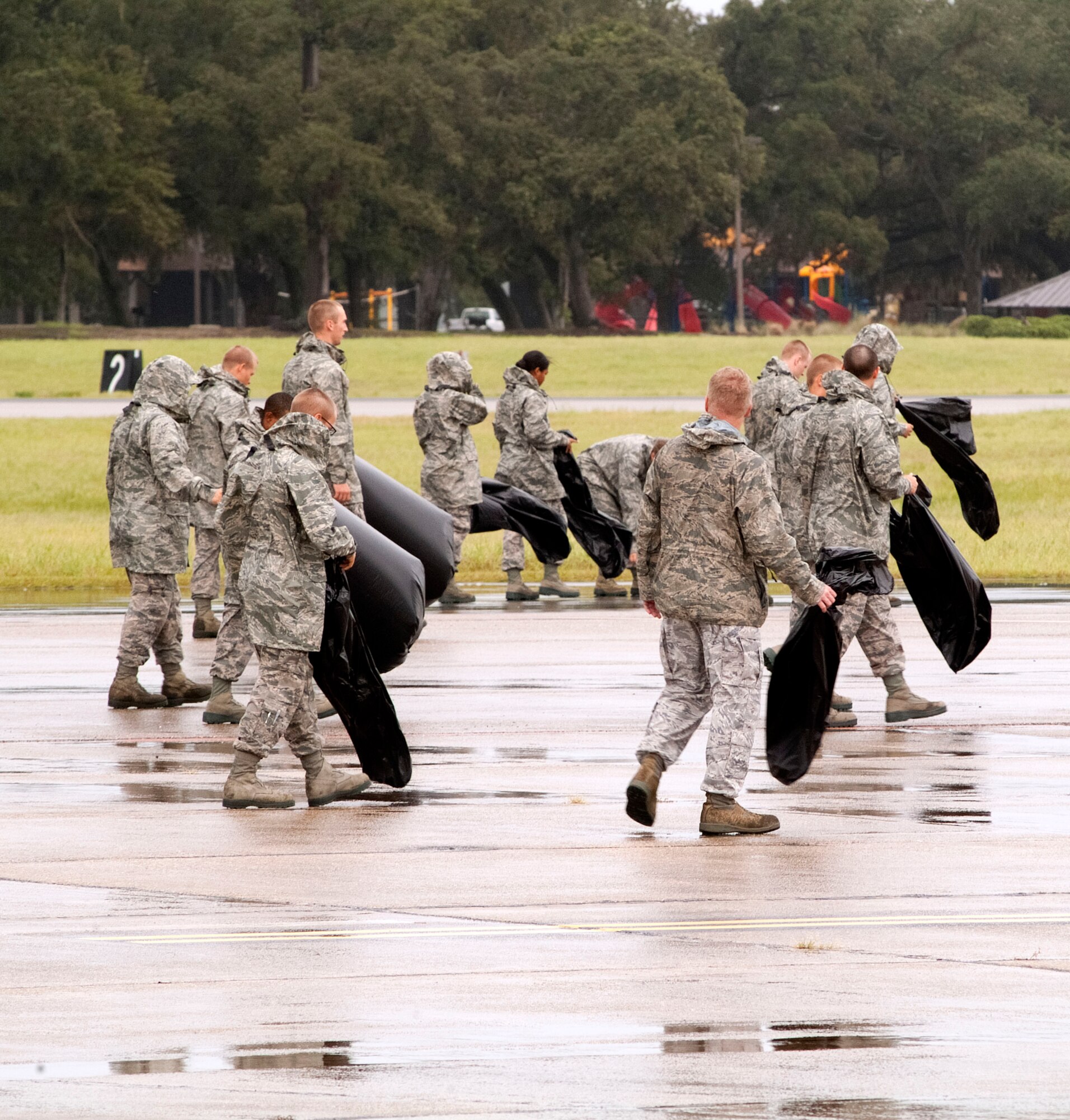 Members of the 334th Training Squadron line up across the flight line to perform a foreign object debris walk Aug. 30, 2012, at Keesler Air Force Base, Miss., during base restoration following landfall of Hurricane Isaac.  The FOD walk was held to clear the flight line of debris that could potentially cause damage to aircraft engines.  In an effort to ensure the safety of Keesler personnel and assets during Hurricane Isaac, the base was closed Aug. 28-29 and reopened Aug. 30 following minimal damage.  (U.S. Air Force photo by Herb Welch)