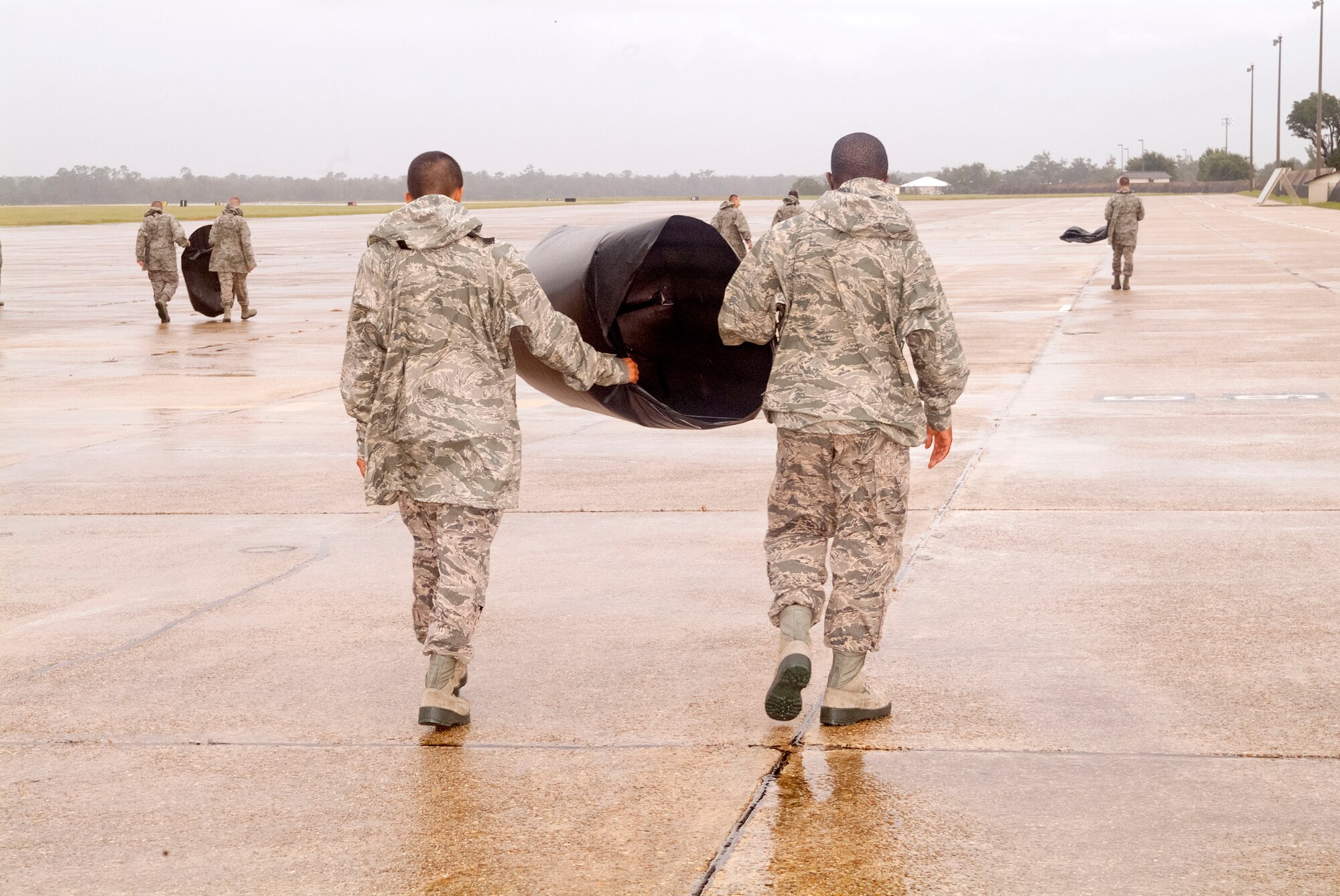 Members of the 334th Training Squadron line up across the flight line to perform a foreign object debris walk Aug. 30, 2012, at Keesler Air Force Base, Miss., during base restoration following landfall of Hurricane Isaac.  The FOD walk was held to clear the flight line of debris that could potentially cause damage to aircraft engines.  In an effort to ensure the safety of Keesler personnel and assets during Hurricane Isaac, the base was closed Aug. 28-29 and reopened Aug. 30 following minimal damage.  (U.S. Air Force photo by Herb Welch)