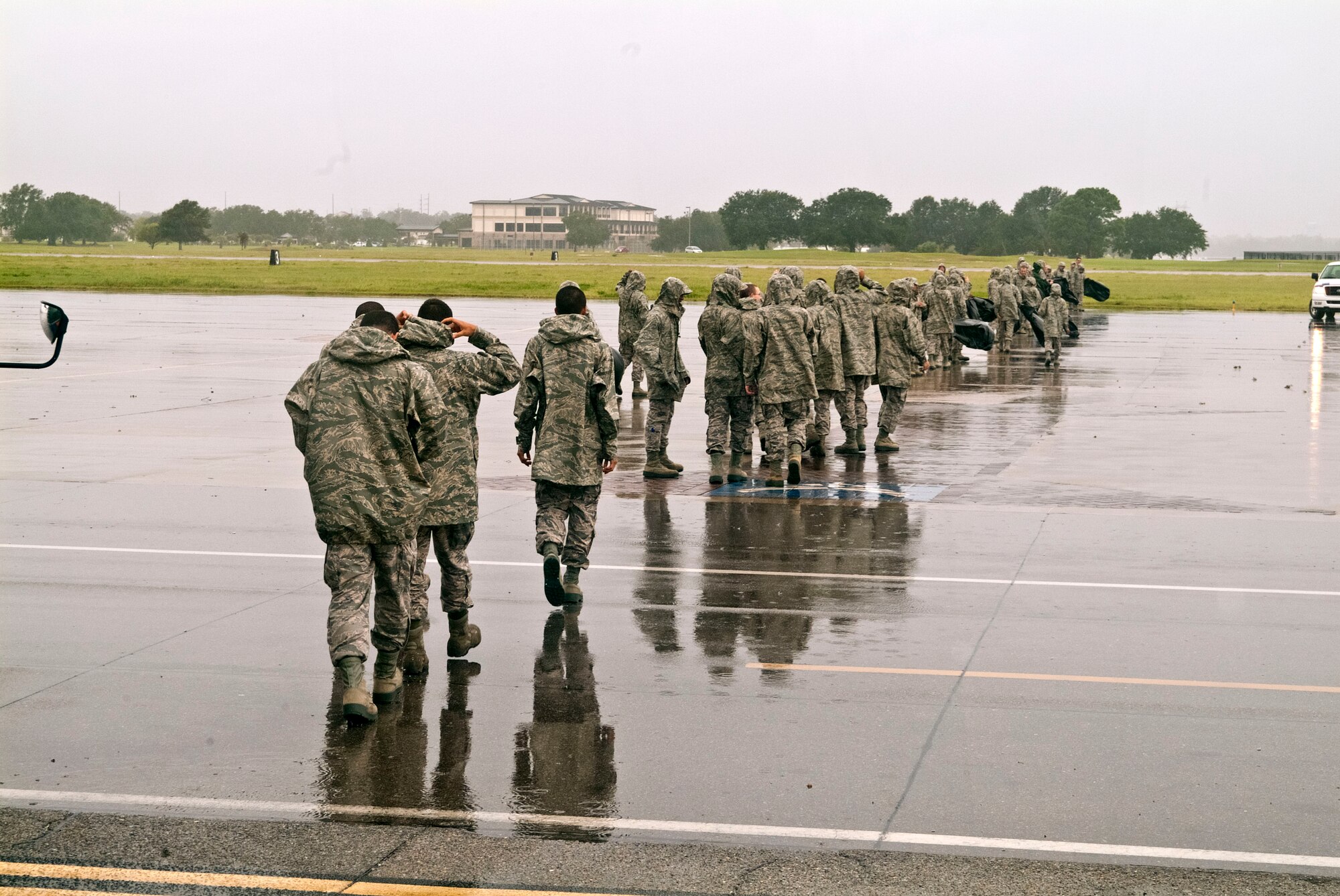 Members of the 334th Training Squadron line up across the flight line to perform a foreign object debris walk Aug. 30, 2012, at Keesler Air Force Base, Miss., during base restoration following landfall of Hurricane Isaac.  The FOD walk was held to clear the flight line of debris that could potentially cause damage to aircraft engines.  In an effort to ensure the safety of Keesler personnel and assets during Hurricane Isaac, the base was closed Aug. 28-29 and reopened Aug. 30 following minimal damage.  (U.S. Air Force photo by Herb Welch)