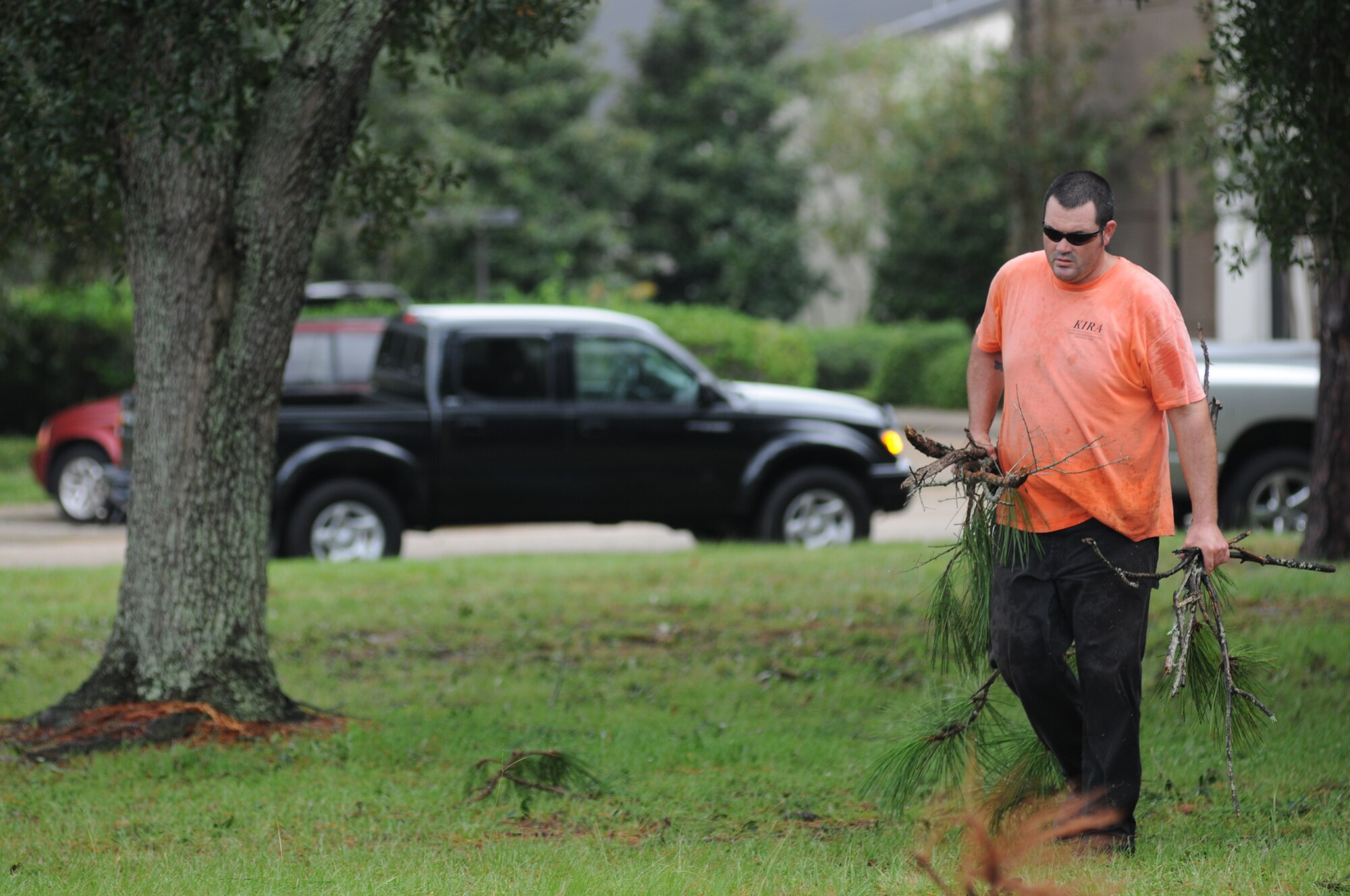 Charles McCloskey, KIRA Facilities Maintenance & Construction, picks up debris across from the wing headquarters building Aug. 30, 2012, at Keesler Air Force Base, Miss., during base restoration following landfall of Hurricane Isaac. In an effort to ensure the safety of Keesler personnel and assets during Hurricane Isaac, the base was closed Aug. 28-29 and reopened Aug. 30 following minimal damage.  (U.S. Air Force photo by Kemberly Groue)