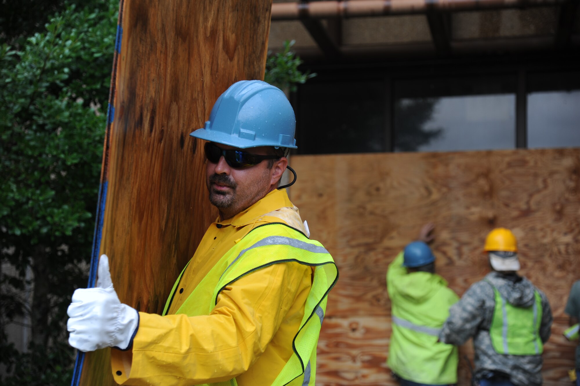 Jason Bullock, CSC, removes boards from the windows of Base Operations center Aug. 30, 2012, at Keesler Air Force Base, Miss., during base restoration following landfall of Hurricane Isaac. In an effort to ensure the safety of Keesler personnel and assets during Hurricane Isaac, the base was closed Aug. 28-29 and reopened Aug. 30 following minimal damage.  (U.S. Air Force photo by Kemberly Groue)