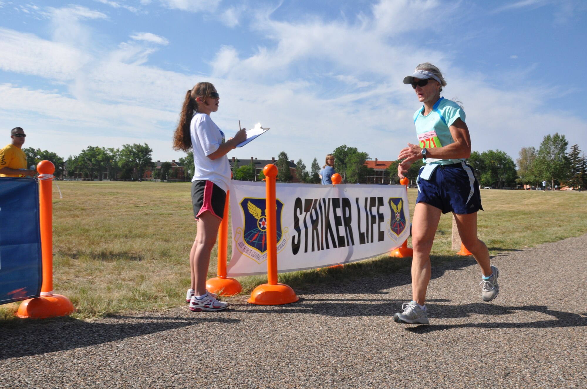 Col. Bridget Gregory, 90th Medical Group commander, crosses the finish line of the Strike Life Half Marathon at F. E. Warren Air Force Base, Wyo., Aug. 24. Gregory finished fastest of all the female competitors with a time of 1:58.17. (U.S. Air Force photo by Senior Airman Dan Gage)