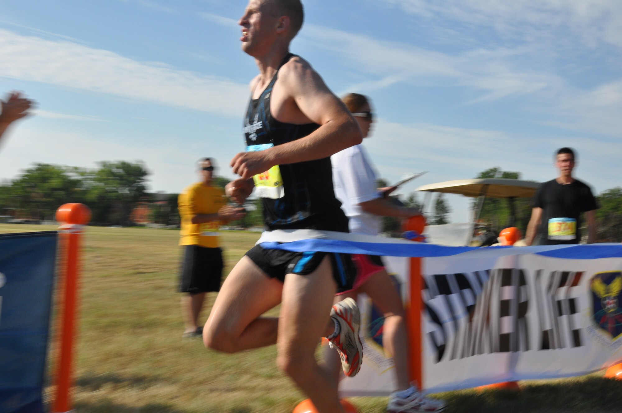 Airman 1st Class Mark Currell, 319th Missile Squadron chef, crosses the line to finish the Striker Life Half Marathon with a time of 1:16.21 at Argonne Parade Field Aug. 24 at F. E. Warren Air Force Base, Wyo. (U.S. Air Force photo by Senior Airman Dan Gage)