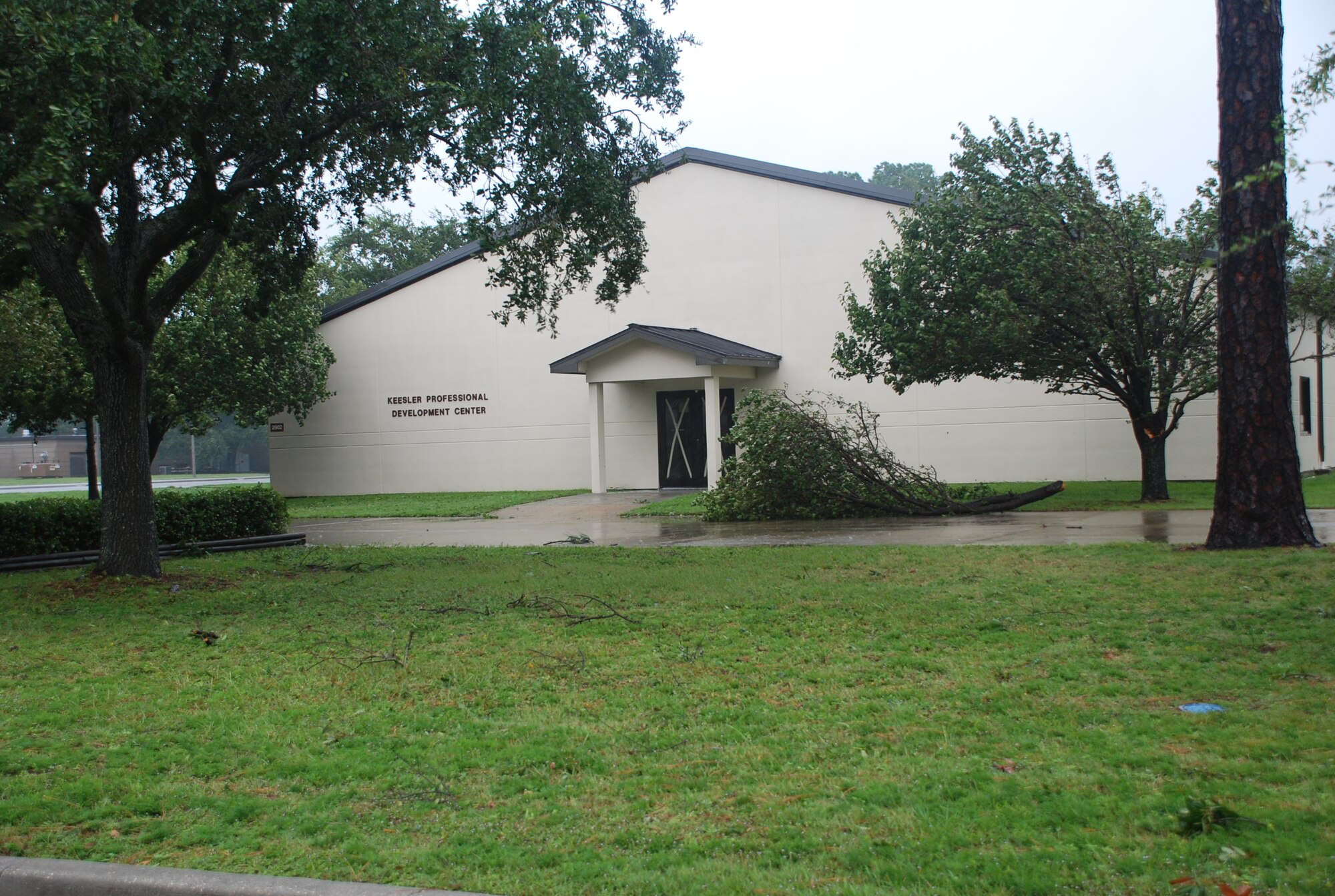 A fallen limb lies on the sidewalk outside the Keesler Professional Development Center at Keesler Air Force Base, Aug. 29, 2012. Strong winds and heavy rains caused minimal damage. In an effort to ensure the safety of Keesler personnel and assets during Hurricane Isaac, the base was closed Aug. 28-29 and reopened Aug. 30.   (U.S. Air Force photo by Staff Sgt. Kimberly Rae Moore)