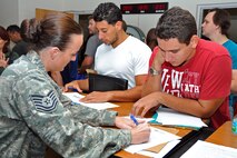 Tech Sgt. Jacklyn Pacheco, 482nd Fighter Wing Financial Management and Comptroller, helps an IRR member with their paper work during the base’s annual muster, Aug. 17. IRR members are composed of former active duty, guard and reserve servicemembers who have time remaining on their military service obligation or on a contracted agreement. Until the end of their obligation they are assigned to the IRR. IRR members do not participate in military activities unless a time of national emergency declared by the president and they are activated.