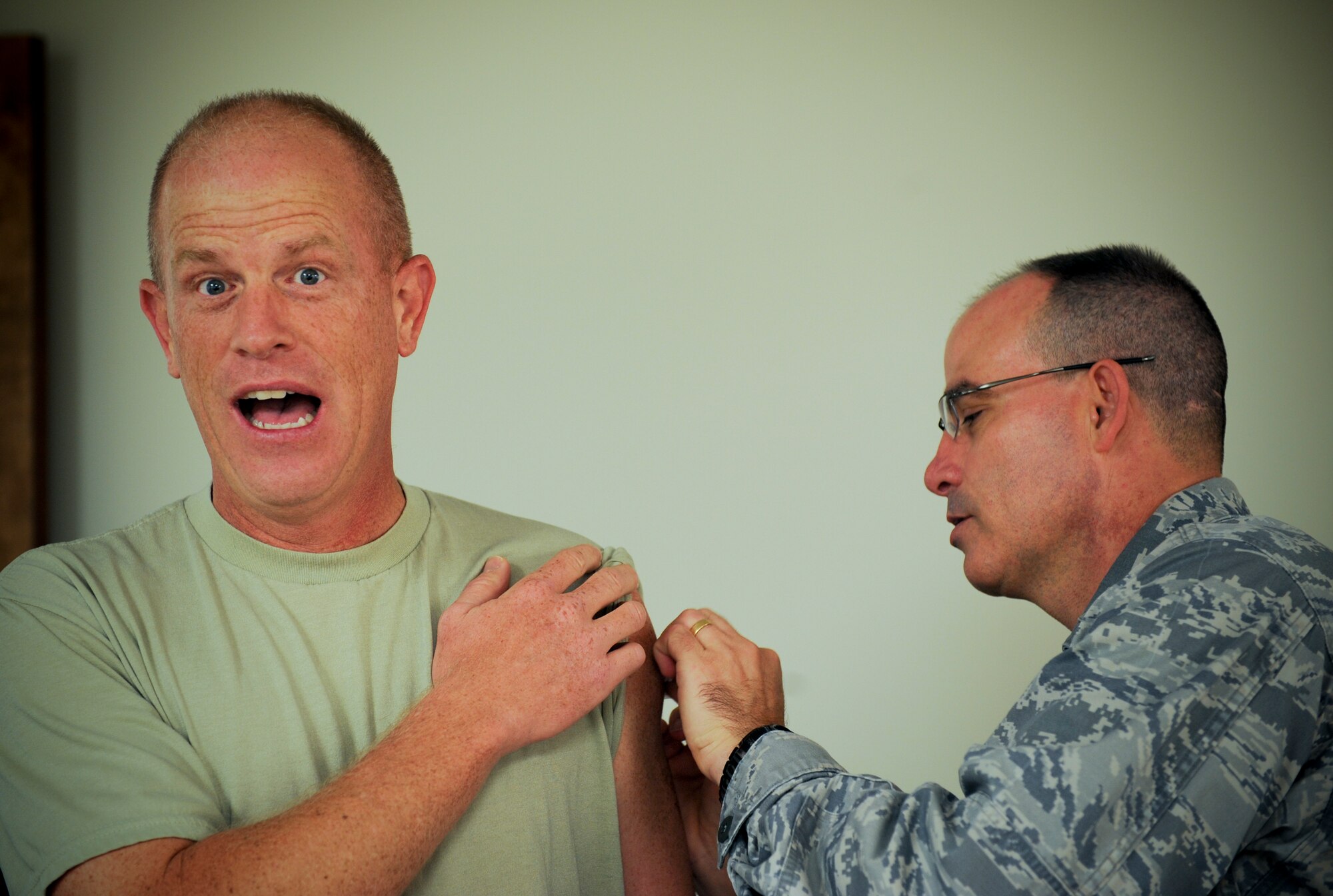 U.S. Air Force Chief Master Sgt. Frank Batten, 23d Wing command chief, receives a flu vaccination from Lt. Col. Louis Gallo, 23d Medical Operations Squadron commander, at Moody Air Force Base, Ga., Aug. 30, 2012. The vaccination is now available at the walk-in immunizations clinic. The clinic is open Monday and Friday from 7:30 a.m. to 4:30 p.m., Tuesday and Thursday from 7:30 a.m.to 4 p.m., and Wednesdays 9 a.m. to 4:30 p.m. (U.S. Air Force photo by Senior Airman Douglas Ellis/Released)  