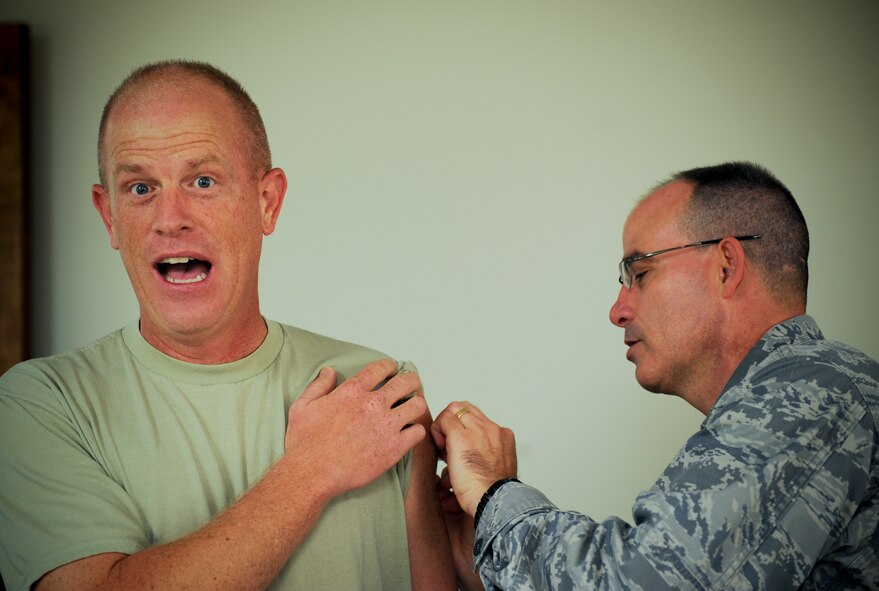 U.S. Air Force Chief Master Sgt. Frank Batten, 23d Wing command chief, receives a flu vaccination from Lt. Col. Louis Gallo, 23d Medical Operations Squadron commander, at Moody Air Force Base, Ga., Aug. 30, 2012. The vaccination is now available at the walk-in immunizations clinic. The clinic is open Monday and Friday from 7:30 a.m. to 4:30 p.m., Tuesday and Thursday from 7:30 a.m.to 4 p.m., and Wednesdays 9 a.m. to 4:30 p.m. (U.S. Air Force photo by Senior Airman Douglas Ellis/Released)  