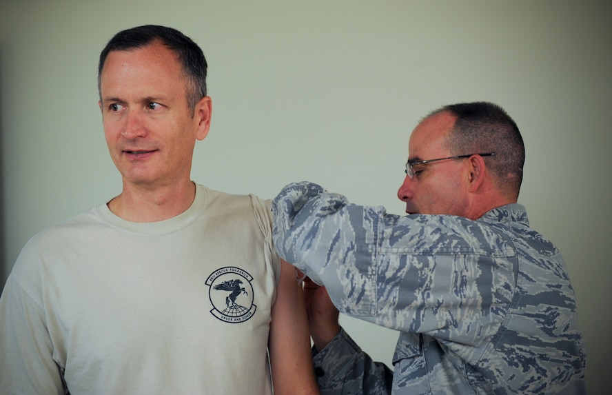 U.S. Air Force Col. Billy Thompson, 23d Wing commander, receives a flu vaccination from Lt. Col. Louis Gallo, 23d Medical Operations Squadron commander, at Moody Air Force Base, Ga., Aug. 30, 2012. The vaccination is an annual requirement for all service members. There will be mass influenza lines at the base auditorium for active duty Airmen Sept. 19 and 20 from 6:30 a.m. to 5 p.m. The 23d Medical Group immunizations clinic will provide influenza vaccinations to retirees, dependents, and civilian personnel beginning Sept. 24. (U.S. Air Force photo by Senior Airman Douglas Ellis/Released) 