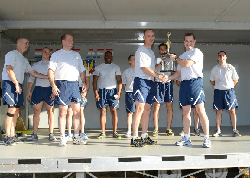 Col. Phil Stewart, 9th Reconnaissance Wing commander (Right), presents the traveling Wing Championship trophy to the winning team from the 548th Intelligence, Surveillance, and Reconnaissance Group August 30, 2012 at Beale Air Force Base, Calif. The Wing Champions Run began immediately before the annual wing formation run and consisted of seven runners competing from each group. (U.S. Air Force photo by Mr. John Schwab/ Released)