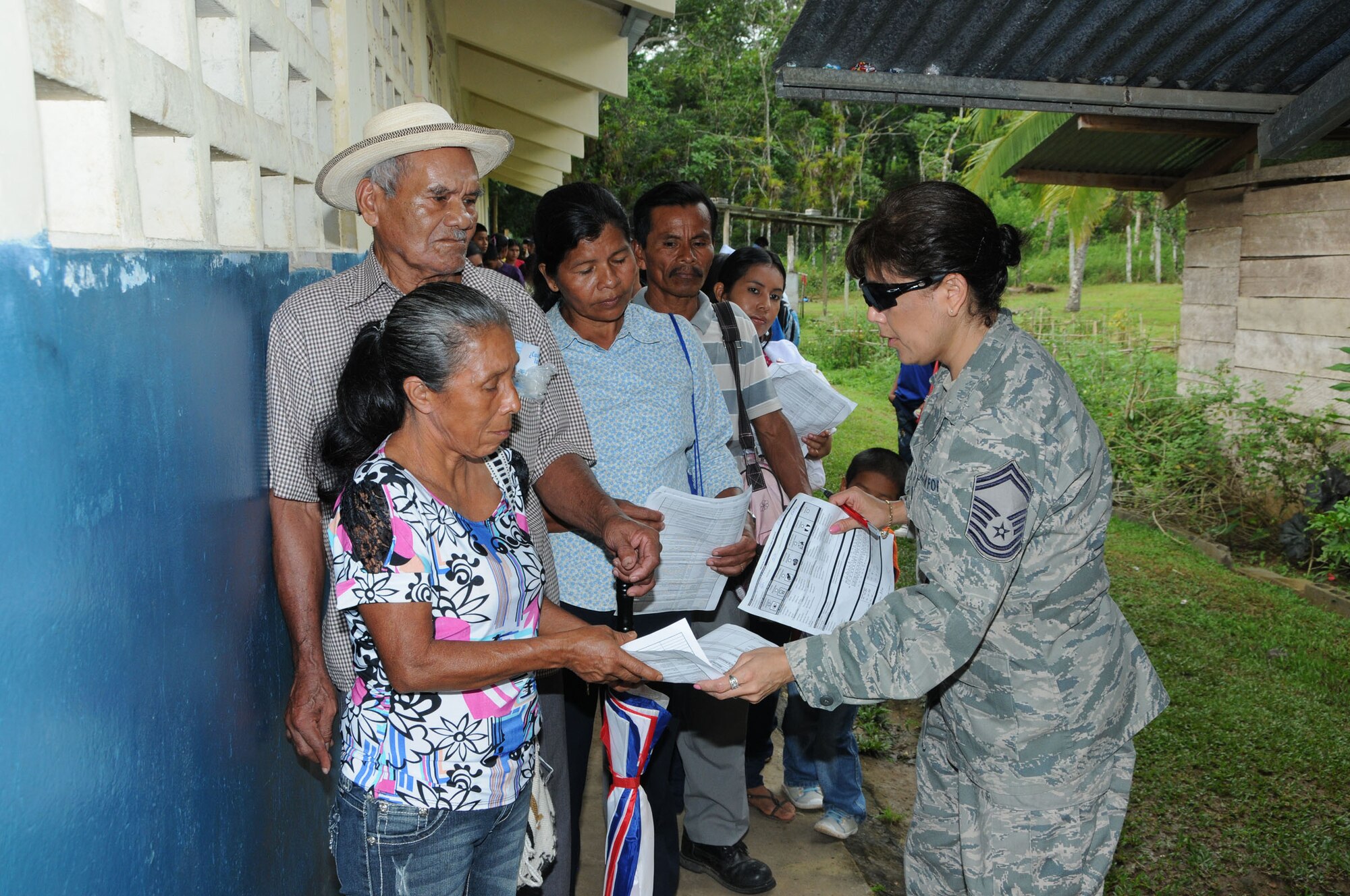 WRIGHT-PATTERSON AIR FORCE BASE, Ohio - Senior Master Sgt. Rose Harris, 445th Aerospace Medicine Squadron, reviews a patient's health forms, guiding them to the appropriate deployed 445th medical care personnel and local ministry of health officials Aug. 20. The patients were seen at Panama's Ministry of Education C.E.B.G. Manuel J. Rodriguez School located in Tecue, Coclé District in Panama. Thirty Airmen from the 445th AMDS and 445th Aeromedical Staging Squadron traveled to Central America with Airmen from March Air Reserve Base, Calif., Joint Base Lewis-McChord, Wash., Robins Air Force Base, Ga., Niagara Falls Air Reserve Station, N.Y., and Westover Air Reserve Base, Mass., in Central America as part of a humanitarian mission to support Panama Medical Readiness Training Exercise (MEDRETE) Aug. 18 to Aug. 31, providing more than 9,000 dental, dermatological, general medicine, optometry and ophthalmology services to more than 5,000 residents living in remote areas who have limited or no access to medical care. (U.S. Air Force photo/Tech. Sgt. Anthony G. Springer)