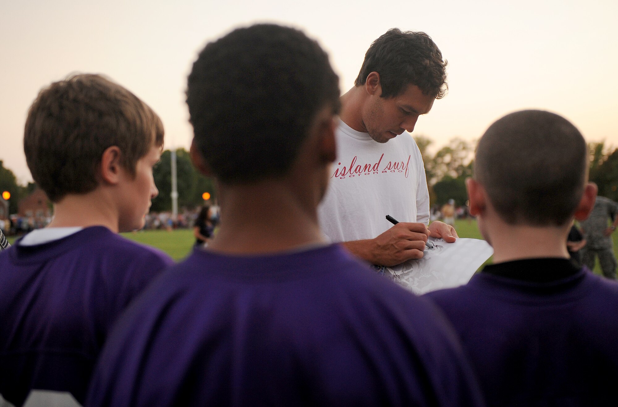 Sam Bradford, St. Louis Rams quarterback, signs autographs for kids Aug. 29 at Scott Air Force Base, Ill. The Rams handed out jerseys, took pictures and signed autographs for as many people as they could before they left for the night. (U.S. Air Force photo/Airman Kristina Lynch)