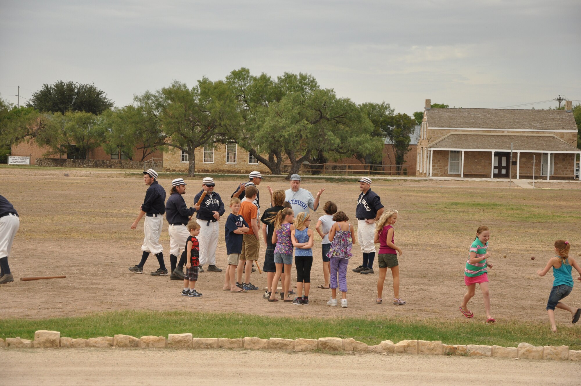 GOODFELLOW AIR FORCE BASE, Texas-- Members of the Fort Concho vintage baseball team play a 1800s version of baseball with military families at the Blue Star Museum event Aug. 25 at the Fort Concho National Historic Landmark. Parents and children were invited to play the sport with the team. Along with participating in activities, families were encouraged to tour the museum and view reconstructed areas within the fort.  (U.S. Air Force photo/ Airman 1st Class Erica Flores)