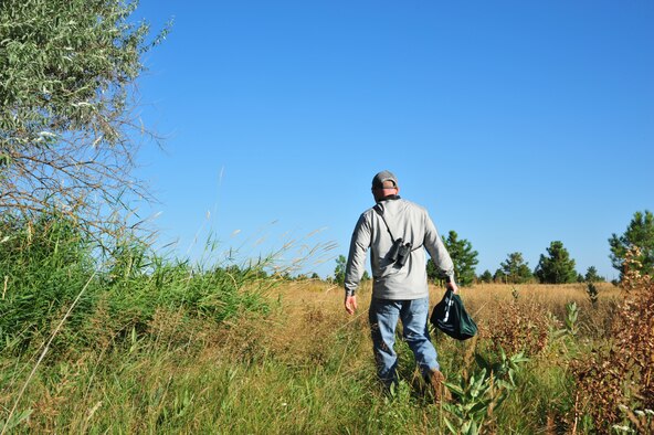 Steven Selser, 92nd Civil Engineer Squadron natural and cultural resources manager, walks into the Fairchild nature trail located near the Survival Evasion Resistance and Escape side of Fairchild Air Force Base Aug. 23, 2012. Selser has been visiting this wildlife environment recently on a daily basis to check bait stations, hunting blinds and other Archery related issues. (U.S. Air Force photo by Airman 1st Class Earlandez Young)