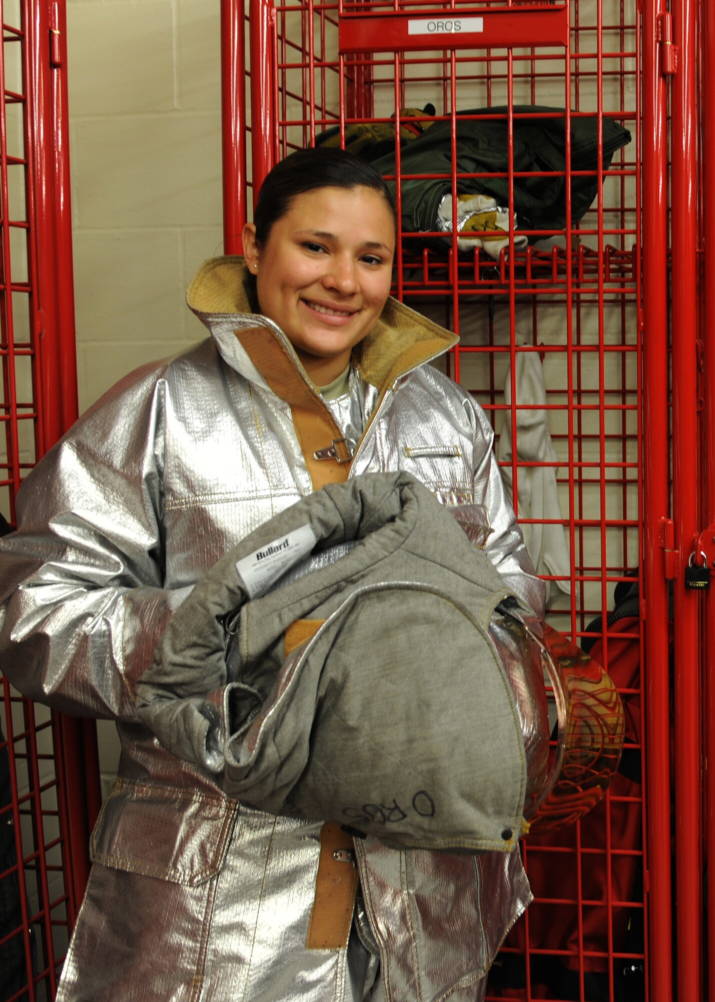 Airman 1st Class Vanessa Oros, 319th Civil Engineer Squadron firefighter, prepares to begin a new shift, Aug. 29, 2012, on Grand Forks Air Force Base, N.D.  Oros has more than two years of firefighting experience with the Air National Guard in Tucson, Ariz., and now works as an active-duty firefighter here. (U.S. Air Force photo/Airman 1st Class Ashley N. Taylor)