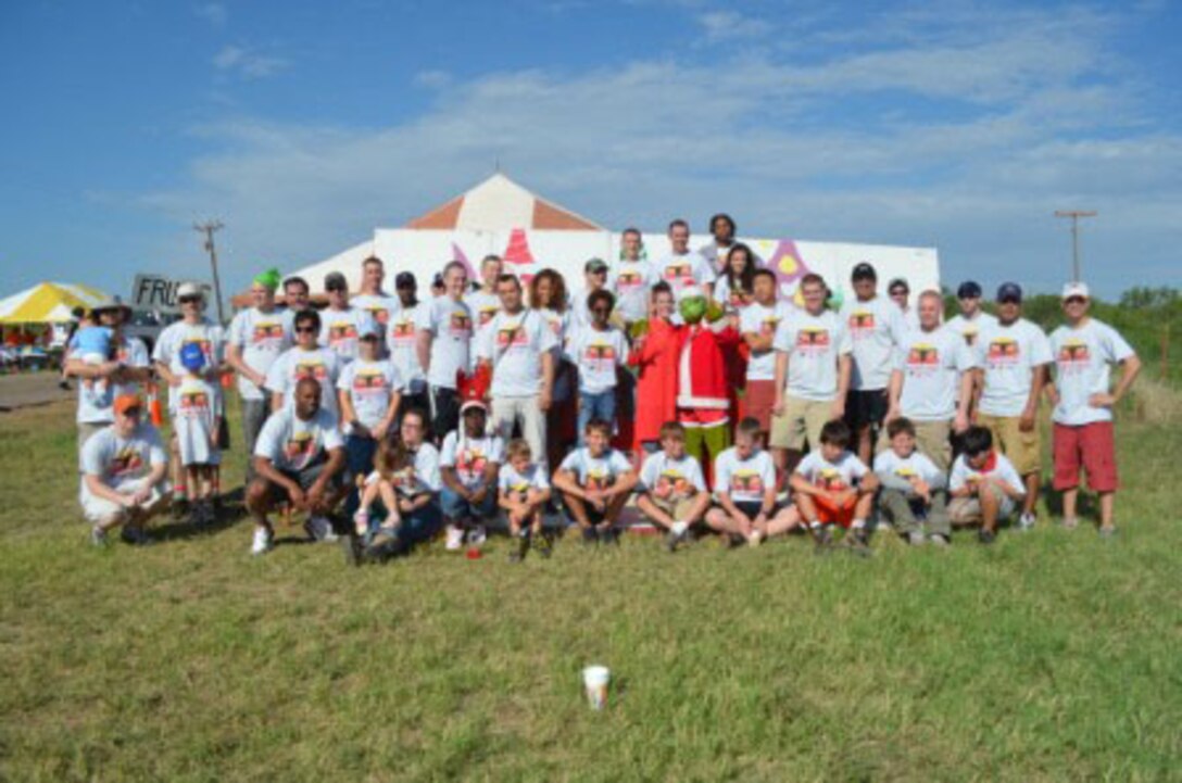Members of the 363rd Training Squadron from Sheppard Air Force Base, Texas, pose with members of Boy Scout Troop 13 during the 31st annual Hotter N' Hell bike race Aug. 25, 2012.  The 363rd TRS and the Boy Scout troop teamed up to run one of the race's pit stops near Electra, Texas. (U.S. Air Force courtesy photo)