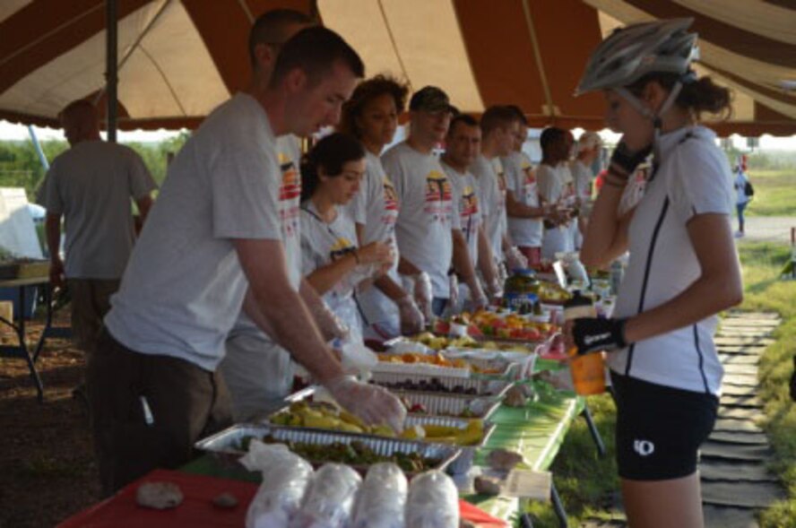 Members of the 363rd Training Squadron from Sheppard Air Force Base, Texas, provide refreshments to cyclists at a pit stop near Electra, Texas, during the 31st annual Hotter N' Hell bike race Aug. 25, 2012.  The 363rd TRS has run the pit stop for the last three races. (U.S. Air Force courtesy photo)