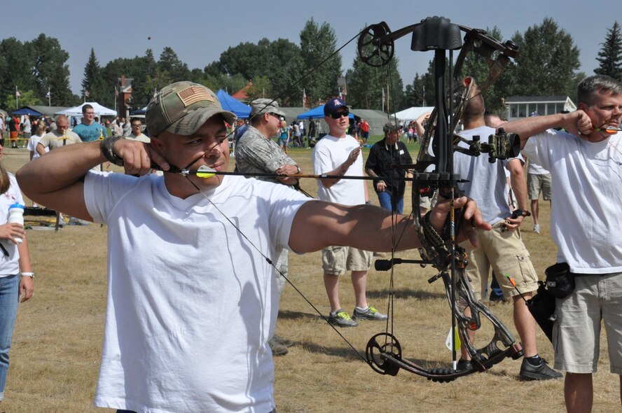 Master Sgt. Jon Mills, 90th Communications Squadron, draws his bow as he takes aim at the archery target during Frontiercade Aug. 24. Mills and his shooting partner, Staff Sgt. Glenn Waldron, 90th CS, took first place in the archery competition. Some other events held during the annual sports day included soccer, volleyball, a half-marathon, horseshoes and a Buffalo Chip Toss. (U.S. Air Force photo by Senior Airman Mike Tryon)