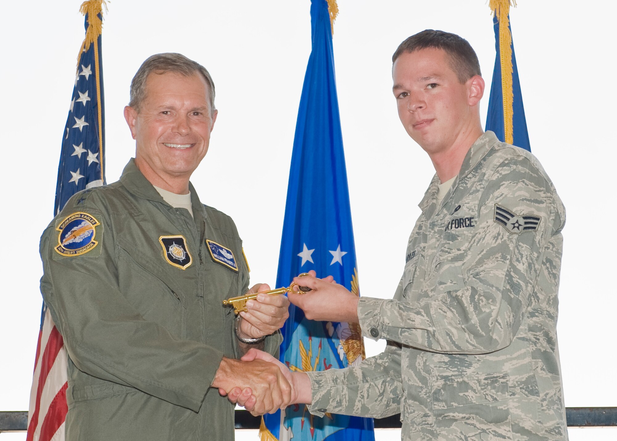 U.S. Air Force Gen. William Fraser III, U.S. Transportation Command commander, left, presents Senior Airman Dustin Markel, 317th Aircraft maintenance Squadron, with the honorary key to the  newest C-130J Super Hercules Aug. 29, 2012, at Dyess Air Force Base, Texas. The aircraft, delivered personally by Fraser, is the 22nd of 28 to be delivered to Dyess by 2013, replacing the current legacy fleet of C-130 H-models. (U.S. Air Force photo by Airmen 1st Class Peter Thompson/ Released)