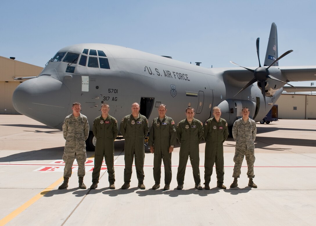 Members of the 317th Airlift Group and U.S. Air Force Gen. William Fraser III, U.S. Transportation Command commander, deliver the newest C-130J Super Hercules Aug. 29, 2012, at Dyess Air Force Base, Texas. The aircraft is the 22nd of 28 to be delivered to Dyess by 2013, replacing the current legacy fleet of C-130 H-models. (U.S. Air Force photo by Airmen 1st Class Peter Thompson/ Released)
