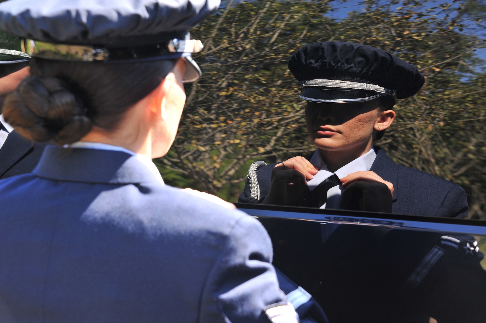 Airman1st Class, Lauren Smith, Maxwell Air Force Base Honor Guard, checks her appearence before a funeral at Alabama National Cemetery, August 22. Maxwell's base honor guard supports requests throughout Alabama and parts of Georgia. (U.S. Air Force photo by Airman 1st Class William Blankenship)