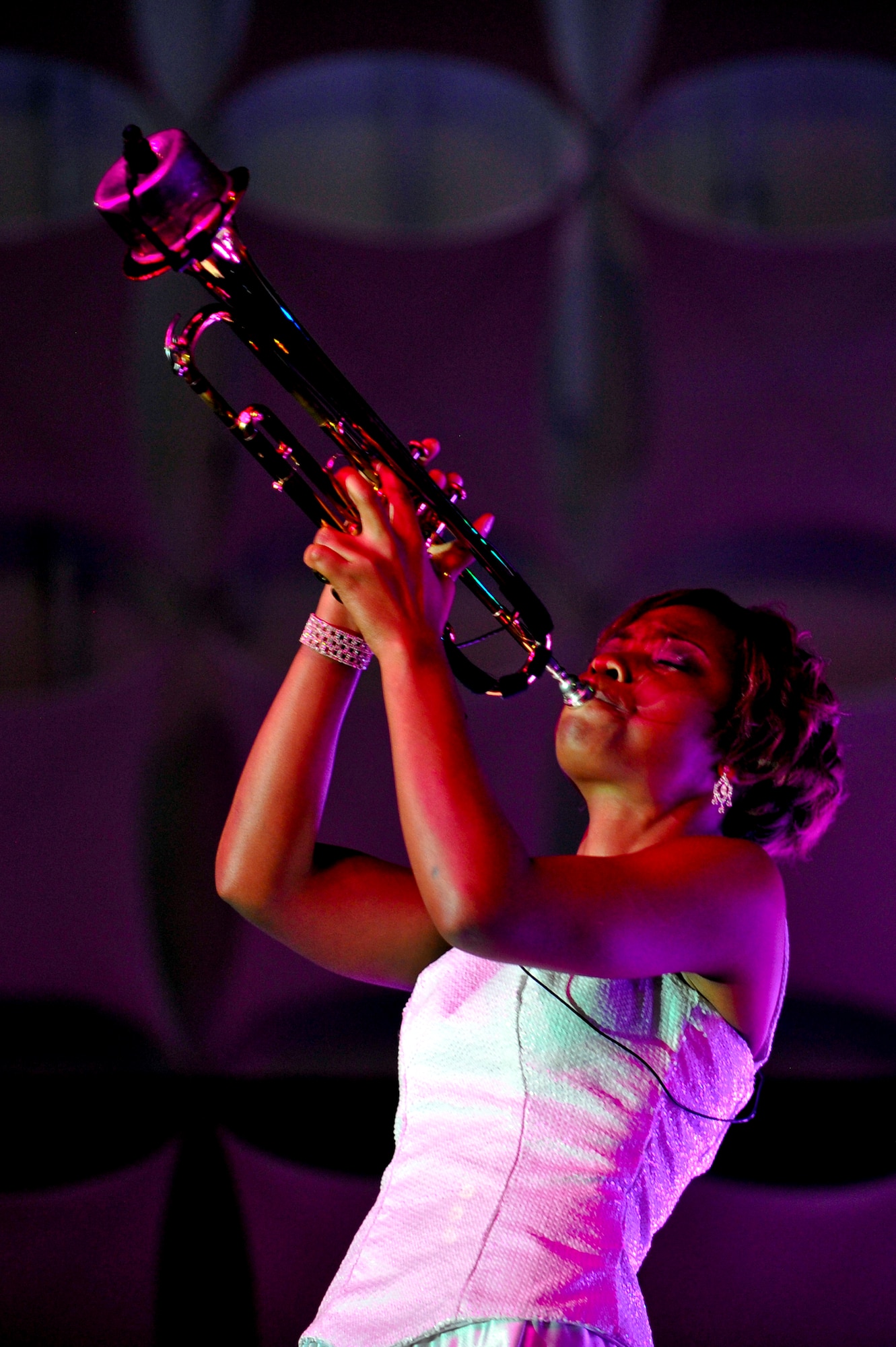 DENVER -- Airman 1st Class Jessica Pitts, 606th Air Control Squadron, Spangdahlem Air Base, Germany, plays a muted trumpet solo at the Wings Over the Rockies Air and Space Museum Aug. 28 for the Tops in Blue "Listen" tour. Performing at a pace of 230 shows in 235 days, Tops in Blue is the Air Force's expeditionary entertainment team that will tour through more than 20 countries this year. (U.S. Air Force photo by Staff Sgt. Kathrine McDowell)