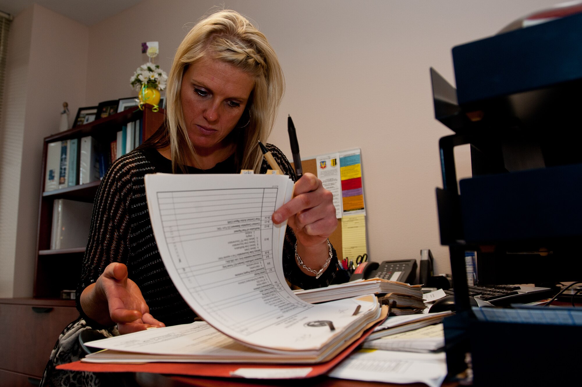 Paula Moore, 28th Contracting Squadron services and commodities team lead, reviews a contract in preparation for the 2013 fiscal year at Ellsworth Air Force Base, S.D., Aug. 24, 2012. At the end of each fiscal year, 28th CONS reviews current contracts to ensure mission needs will be covered in the upcoming fiscal year, and Ellsworth will be able to accomplish its mission. (U.S. Air Force photo by Airman 1st Class Kate Thornton/Released)