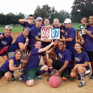 The AlcoBALLics hold up the final score of their championship victory in the “Kick Balls, Save Lives” Kickball Tournament, Aug. 18, 2012, at Ann Morrison Park in Boise, Idaho. Originally, the tournament’s proceeds were to be distributed to various local families affected by cancer, but when one of the victims passed shortly before the tournament, the funds went directly to her relatives instead. (Courtesy photo)

