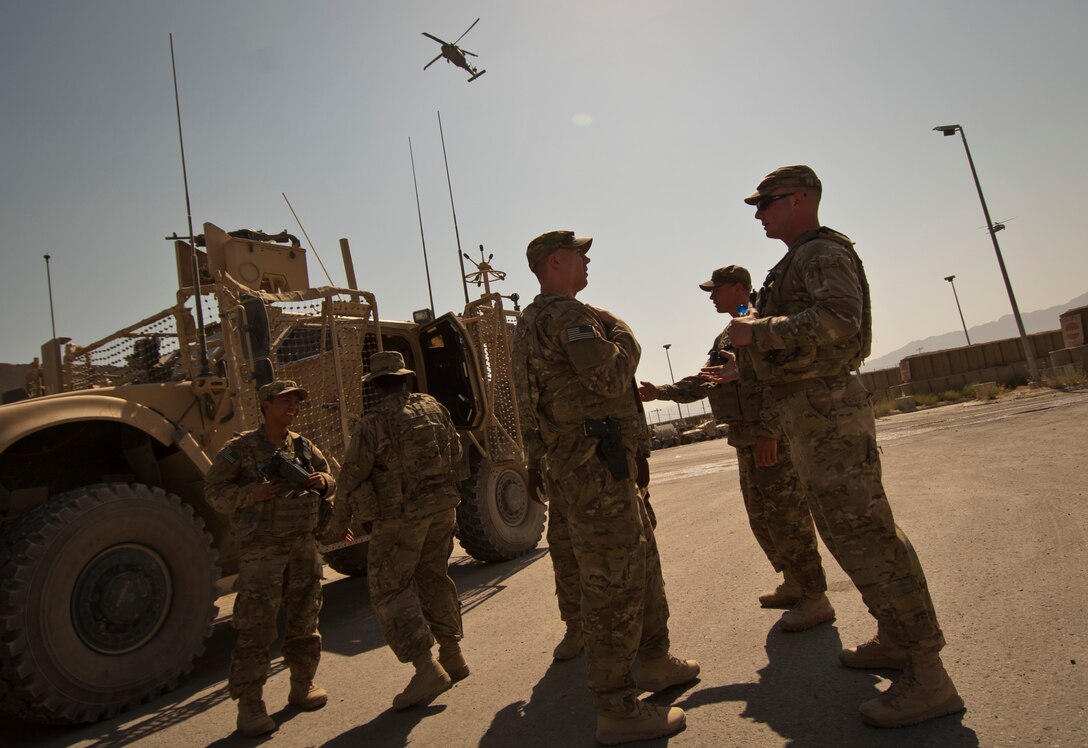 A UH-60 Black Hawk Helicopter flies over Airmen from the 455th Expeditionary Security Forces Squadron as they prepare for a mission at Bagram Airfield Afghanistan, Aug. 18, 2012. Hundreds of Security Forces Airmen keep a constant vigil on Bagram, ready to deter, engage and defeat any potential threats.  (U.S. Air Force Photo/Capt. Raymond Geoffroy)