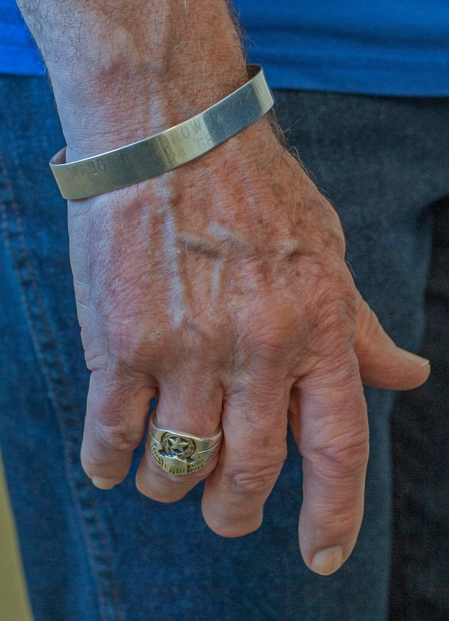 Retired Brig. Gen. Steve Ritchie wears a bracelet in memory of a fallen Airman and an Air Force ring while visiting the 555th Fighter Squadron at Aviano Air Base, Italy Aug. 28. Ritchie wears the items as a reminder of his fellow Airmen and the hard work everyone is respondsible for while accomplishing the mission. (U.S. Air Force Photo/Airman 1st Class Matthew Lotz)