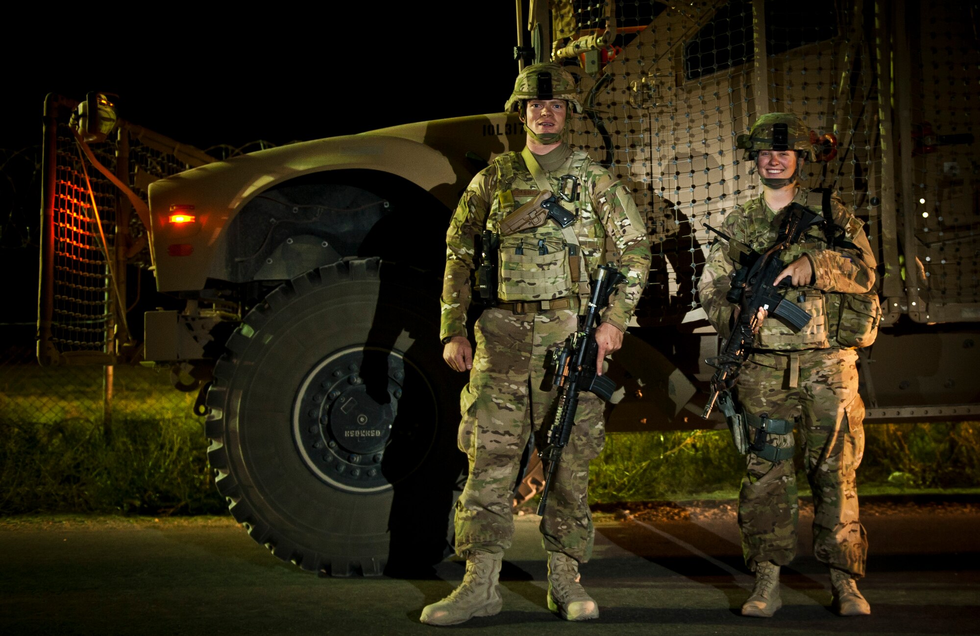 SSgt Elijah Langhorn and A1C Kirsten Hamilton, perimeter response team Airmen assigned to the 455th Expeditionary Security Forces Squadron, stand in front of their tactical vehicle during a sweep of the outer perimeter at Bagram Airfield Afghanistan, Aug. 17, 2012. Bagram defenders utilize a combination of static and mobile teams to protect the base from outside threats. (U.S. Air Force Photo/Capt. Raymond Geoffroy)