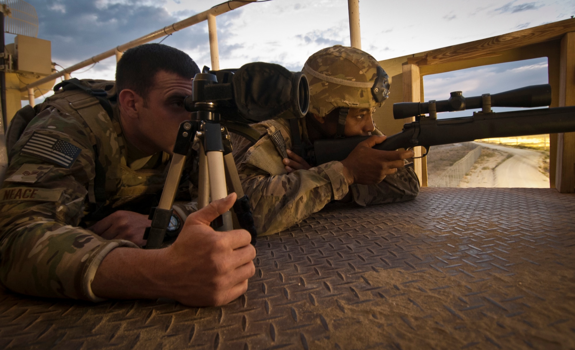 SSgt James Neace and SrA Vincente Carter, Advanced Designated Marksmen deployed to the 455th Expeditionary Security Forces Squadron scan for activity along the base perimeter at Bagram Airfield Afghanistan, Aug. 17, 2012. The ADM team’s specialized equipment and skilled marksmanship enable Bagram defenders to identify and, if needed, defeat threats the base from long distances. (U.S. Air Force Photo/Capt. Raymond Geoffroy)