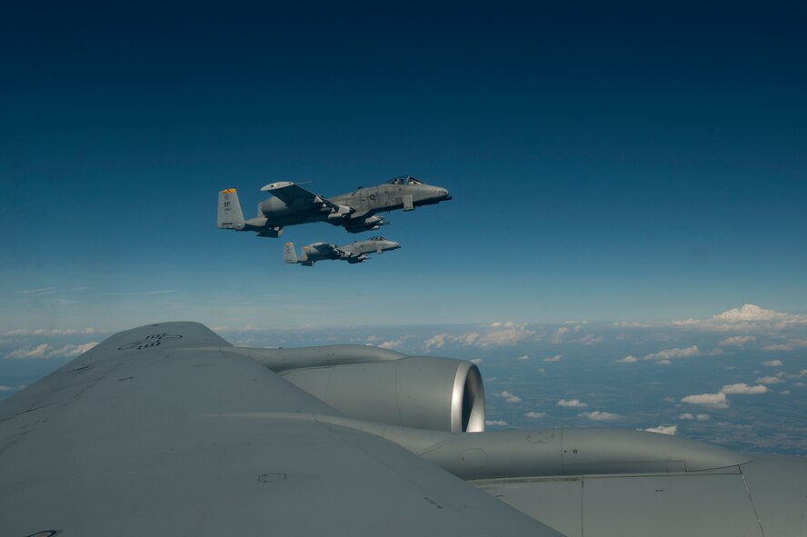 SPANGDAHLEM AIR BASE, Germany – A-10 Thunderbolt II aircraft from the 81st Fighter Squadron fly in formation here Aug. 30 alongside a 351st Air Refueling Squadron KC-135 Stratotanker from Royal Air Force Mildenhall, England after refueling during an orientation flight for 52nd Fighter Wing spouses. The flight allowed spouses to get an up-close view of 81st FS aircraft from Spangdahlem AB during in-flight refueling. The 351st ARS and 52nd FW aircrew train together to enhance their interoperability to perform in-flight refueling missions. (U.S. Air Force photo by Airman 1st Class Dillon Davis/Released)
