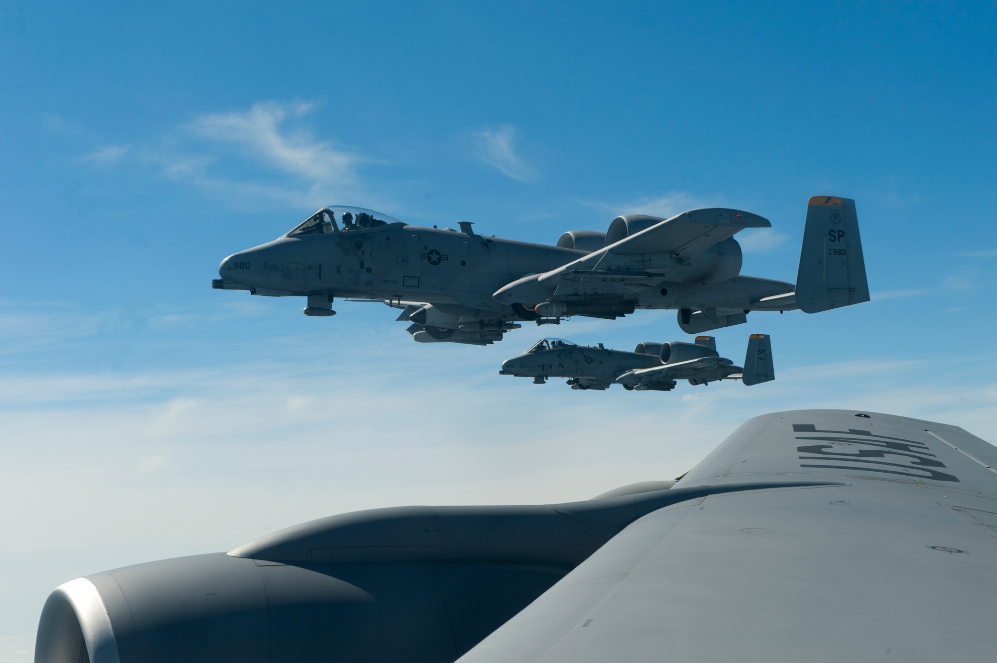 SPANGDAHLEM AIR BASE, Germany – A-10 Thunderbolt II aircraft from the 81st Fighter Squadron fly in formation here Aug. 30 alongside a 351st Air Refueling Squadron KC-135 Stratotanker from Royal Air Force Mildenhall, England after refueling during an orientation flight for 52nd Fighter Wing spouses. The flight allowed spouses to get an up-close view of 81st FS aircraft from Spangdahlem AB during in-flight refueling. The 351st ARS and 52nd FW aircrew train together to enhance their interoperability to perform in-flight refueling missions. (U.S. Air Force photo by Airman 1st Class Dillon Davis/Released)