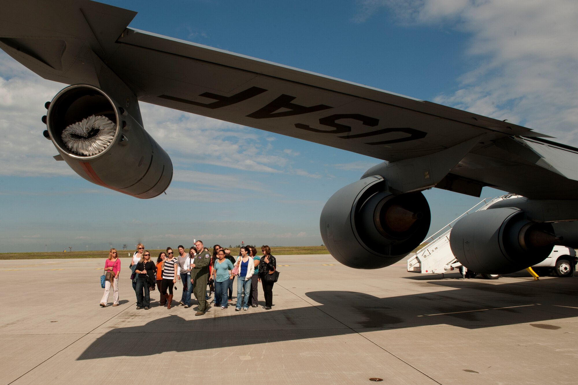 SPANGDAHLEM AIR BASE, Germany – Spouses from the 52nd Fighter Wing tour the exterior of a 351st Air Refueling Squadron KC-135 Stratotanker here Aug. 30 before an orientation flight. The flight allowed spouses to get an up-close view of 81st Fighter Squadron aircraft from Spangdahlem AB during in-flight refueling. The 351st ARS and 52nd FW aircrew train together to enhance their interoperability to perform in-flight refueling missions. (U.S. Air Force photo by Airman 1st Class Dillon Davis/Released)