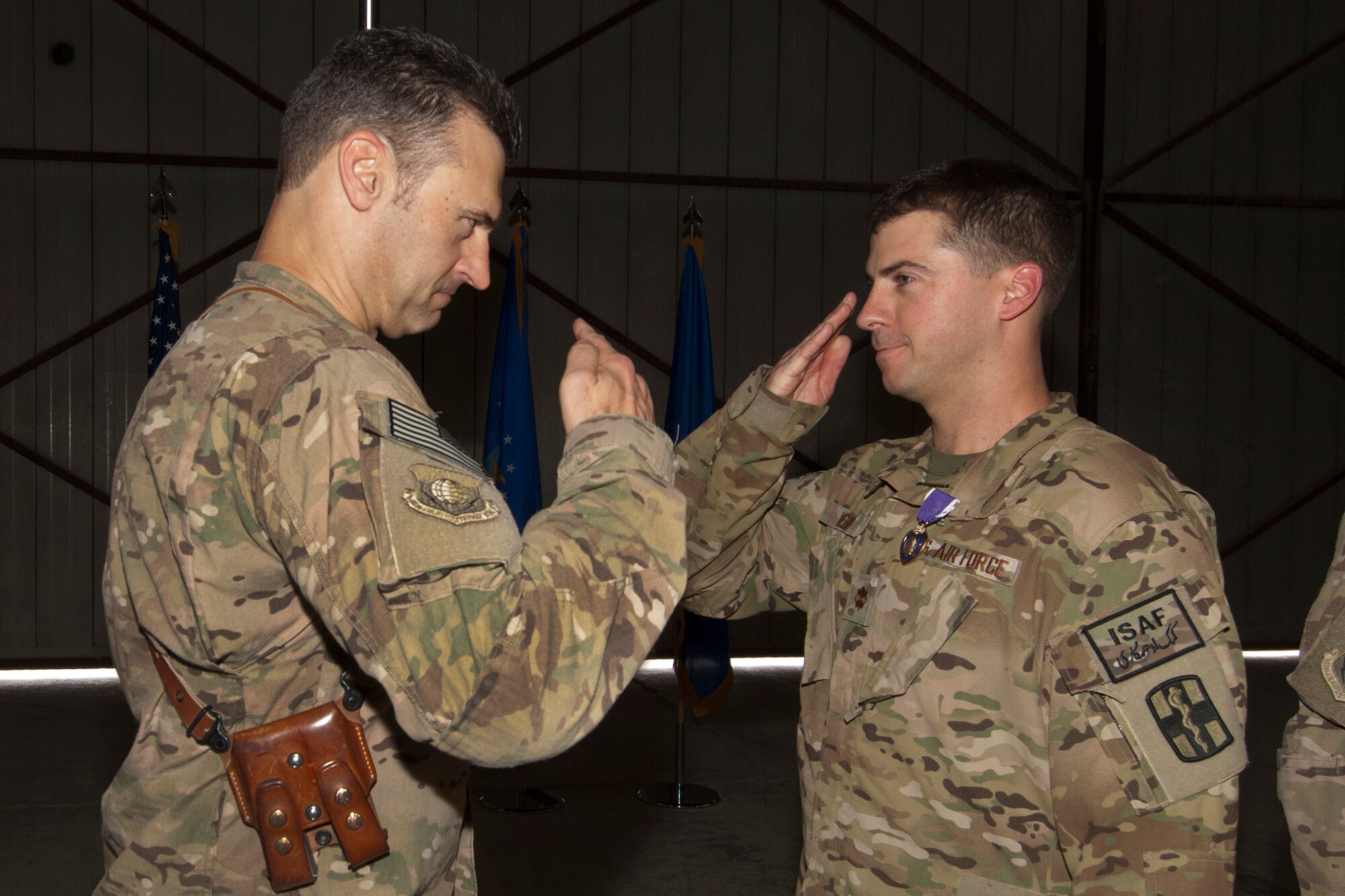 Brig. Gen. Joseph Guastella, Commander 455th Air Expeditionary Wing, presents a Purple Heart to Maj. James Webb, a Critical Care Nurse assigned to the U.S. Army’s 966th Forward Surgical Team, Task Force-Medical Alpha, at Bagram Airfield, Afghanistan, Aug. 28, 2012. Webb was serving as part of the medical evacuation crew in the central Ghazni Province of Afghanistan when he was shot by an enemy AK-47 while loading a patient aboard his helicopter. (U.S. Air Force photo/SSgt Jeff Nevison)