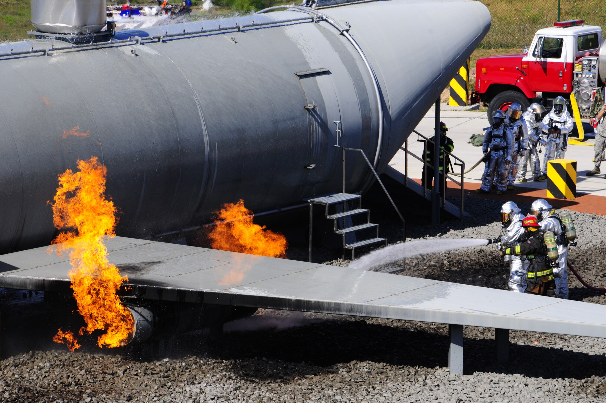Air Force fire fighters respond to a simulated contained fire exercise during Silver Flag Aug. 23, 2012 on Ramstein Air Base, Germany. Silver Flag is a weeklong training program for Airmen from various bases to prepare for deployment. (U.S. Air Force photo/ Airman 1st Class Hailey Haux) 