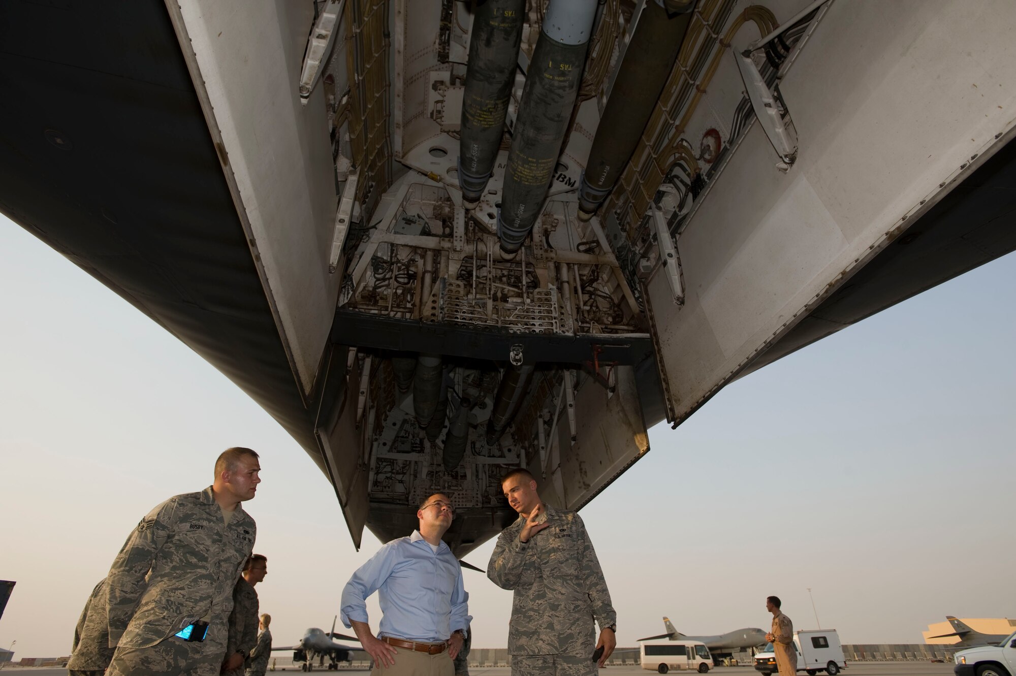 1st Lt. Stephen Pruitt, 379th Expeditionary Aircraft Maintenance Squadron, briefs Mr. Daniel Ginsberg, Assistant Secretary of the Air Force for Manpower and Reserve Affairs, on the B-1 Lancers airpower capabilities while touring the 379th Air Expeditionary Wing's flightline during his visit, Southwest Asia, August 29, 2012. Mr. Ginsberg is responsible for providing overall supervision of manpower, military and civilian personnel, Reserve component affairs, and readiness support for the Department of the Air Force. (U.S. Air Force photo/Staff Sgt. Sheila deVera)
