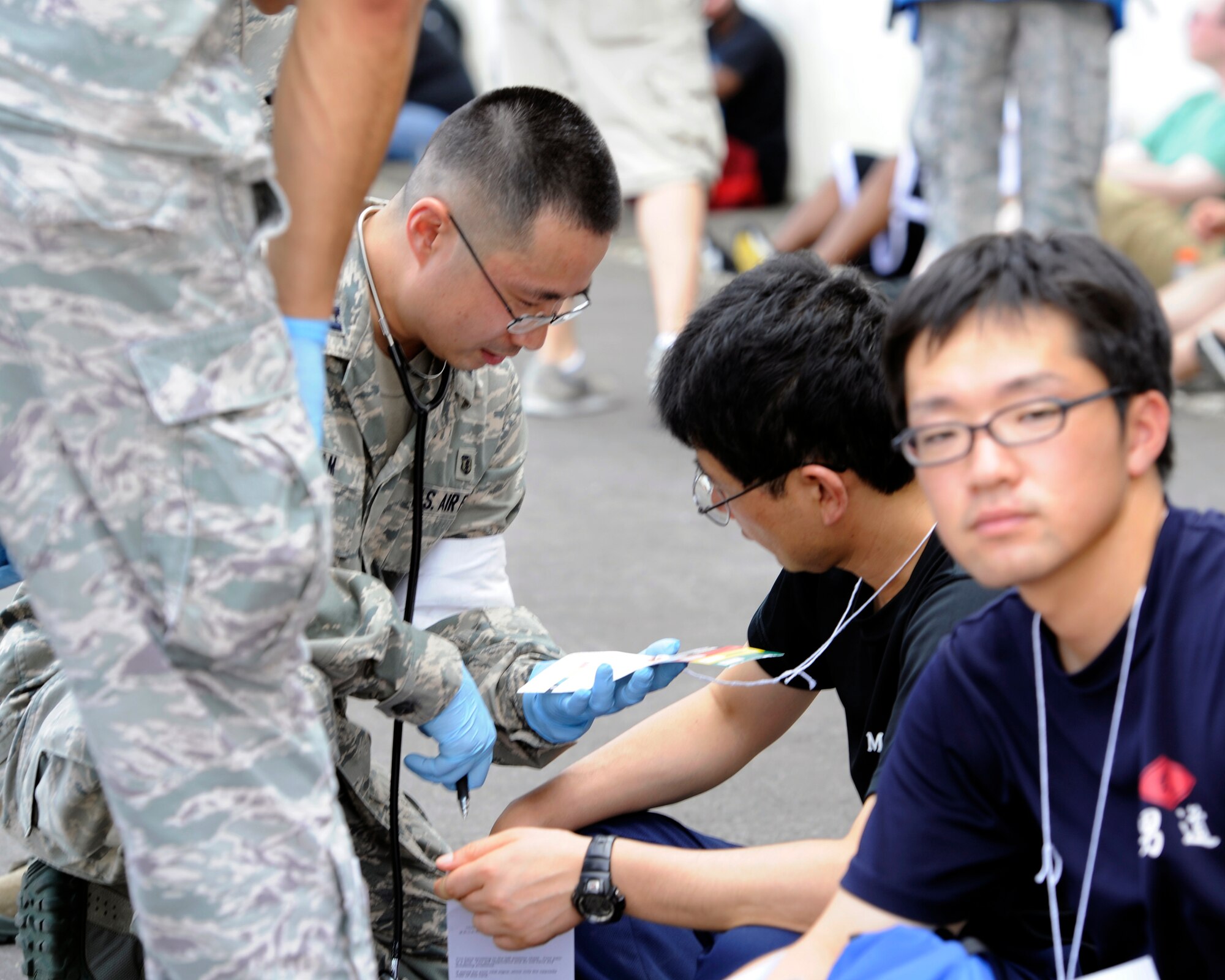 An Air Force emergency responder assigned to the 35th Medical Group attends to a simulated  casualty during a major accident response exercise (MARE), at Misawa Air Base, Japan, Aug. 30, 2012. The 35th Fighter Wing and Japan Air Self-Defense Force conducts this annual bilateral exercise to ensure emergency responders are prepared to effectively handle a mass casualty situation. (U.S. Navy photo by Mass Communications Specialist 2nd Class Pedro A. Rodriguez/RELEASED)