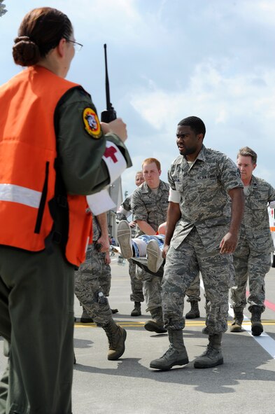 Air Force emergency responders assigned to the 35th Medical Group carry a simulated casualty on a stretcher during a major accident response exercise (MARE), at Misawa Air Base, Japan, Aug. 30, 2012. The 35th Fighter Wing and Japan Air Self-Defense Force conducts this annual bilateral exercise to ensure emergency responders are prepared to effectively handle a mass casualty situation. (U.S. Navy photo/Mass Communications Specialist 2nd Class Pedro A. Rodriguez/Released) 
