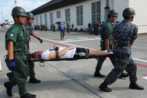 Members of the Japan Air Self-Defense Force carry a simulated victim on a stretcher during a major accident response exercise at Misawa Air Base, Japan, Aug. 30, 2012. The purpose of a MARE is to test the response actions of emergency-response and medical personnel. (U.S. Air Force photo by Airman 1st Class Kia Atkins/Released)