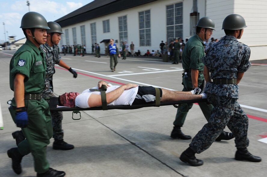 Members of the Japan Air Self-Defense Force carry a simulated victim on a stretcher during a major accident response exercise at Misawa Air Base, Japan, Aug. 30, 2012. The purpose of a MARE is to test the response actions of emergency-response and medical personnel. (U.S. Air Force photo/Airman 1st Class Kia Atkins/Released) 
