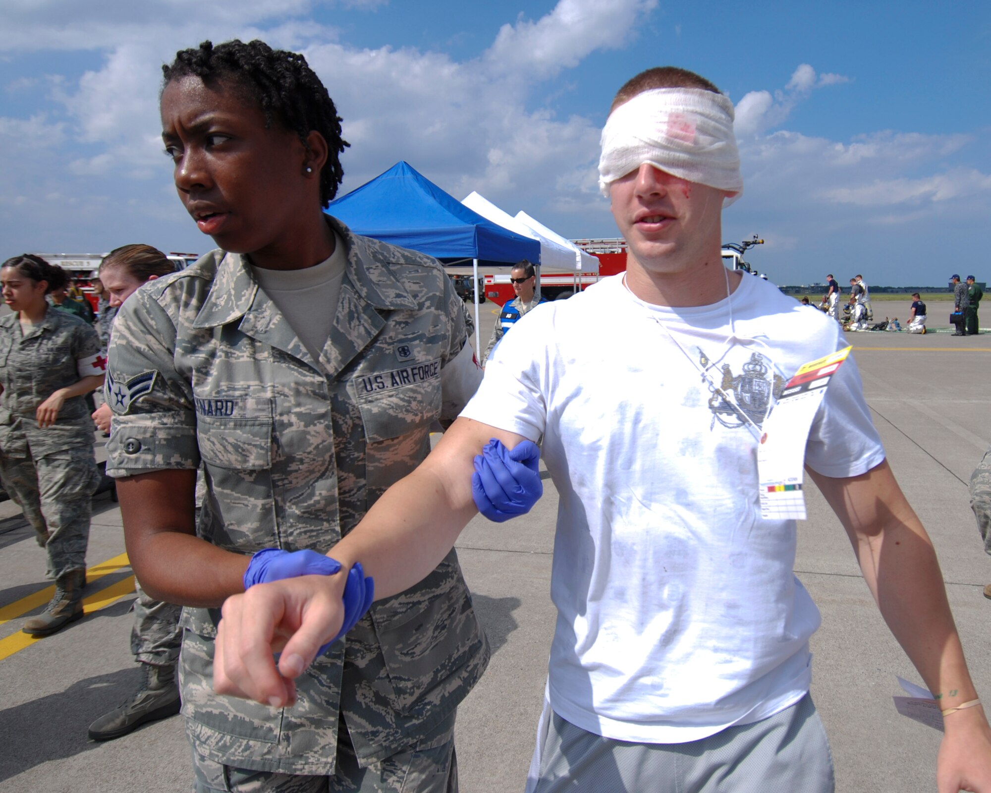 A U.S. Air Force emergency responder from the 35th Medical Group evacuates a simulated casualty during a major accident response exercise (MARE) at Misawa Air Base, Japan, Aug. 30, 2012. Misawa Air Base conducts this exercise annually to demonstrate the effectiveness of the base personnel's ability to handle a mass casualty situation. (U.S. Navy photo by Mass Communication Specialist 2nd Class Kenneth G. Takada/Released)